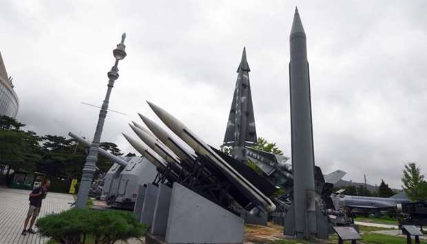 A man looks at replicas of a North Korean Scud-B missile (R) and South Korean missiles at the Korean War Memorial in Seoul
