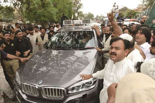 The vehicle of Pakistani former prime minister Nawaz Sharif is surrounded by supporters and activists during a rally in Rawalpindi yesterday.