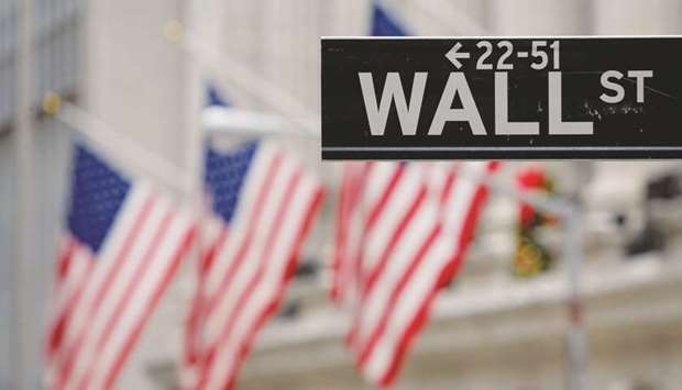 A Wall Street sign is seen outside the New York Stock Exchange. US markets have been buoyant as of the nearly 300 companies in the S&P 500 that have reported results thus far, more than three-fourths have bested earnings expectations, according to Wells Fargo Advisors.