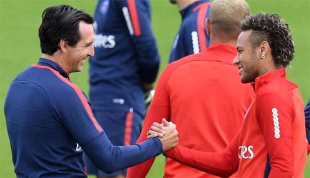 Paris Saint-Germain's Brazilian forward Neymar shakes hands with the club's head coach Unai Emery during a training session at the Camp des Loges in Saint-Germain-en-Laye, near Paris, on Friday.