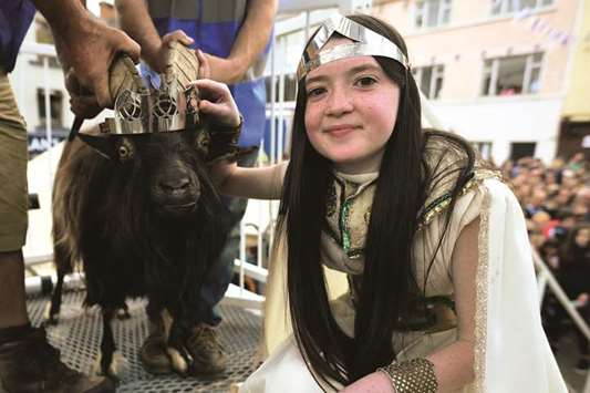 Puck Queen Caitlin Horgan, 12, poses with the newly-crowned King Puck goat, in Killorglin.
