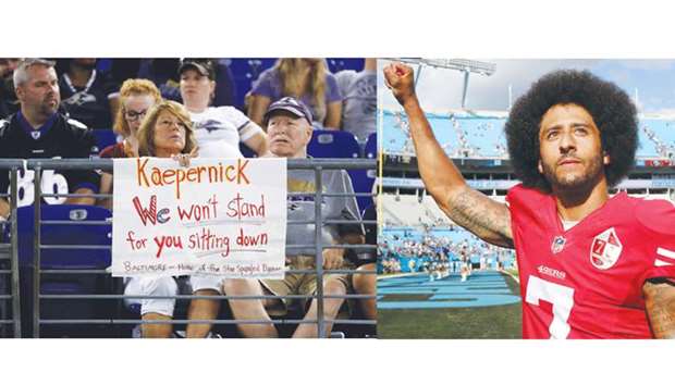 A fan sits behind a sign referring to former San Francisco 49ers quarterback Colin Kaepernick (right) in the second half of the Washington Redskins and Baltimore Ravens preseason game in Baltimore, Maryland, on Thursday. (AFP)
