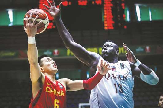 Chinau2019s Ailun Guo attempts to score against Qatar during the 2017 FIBA Asia Cup basketball tournament in Beirut yesterday.