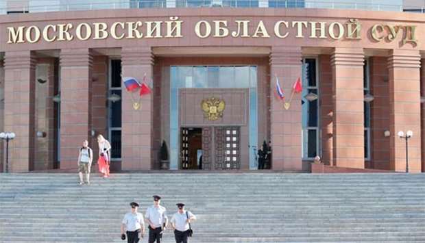 People walk outside the Moscow regional court building, where the incident happened.