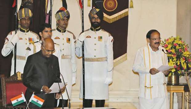 Indian President Ram Nath Kovind administers the oath of the new Vice President Venkaiah Naidu during a swearing-in ceremony at the presidential palace in New Delhi.
