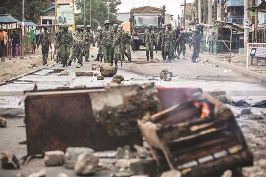 Police officers on patrol following a protest by supporters of the National Super Alliance (NASA) opposition coalition presidential candidate at Mathare slum in Nairobi.