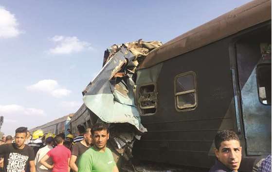 Egyptians look at the crash of two trains that collided near the Khorshid station in Egyptu2019s coastal city of Alexandria, Egypt, yesterday.