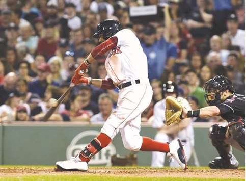 Boston Red Sox right fielder Mookie Betts hits an RBI single during the fourth inning of the Major League Baseball match against the Cleveland Indians at Fenway Park in Boston on Sunday night. (USA TODAY Sports)