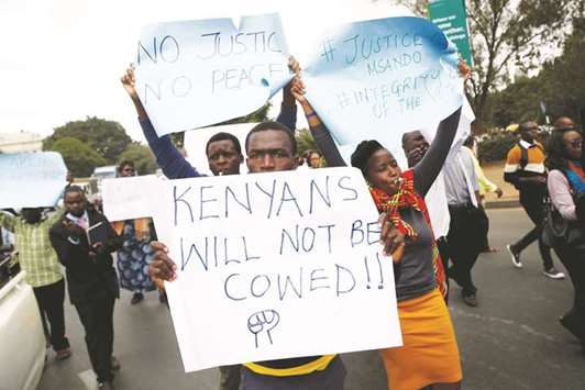 Demonstrators carry placards during a protest over the death of senior Kenyan election official Chris Msando, who was found murdered on Monday in Nairobi.