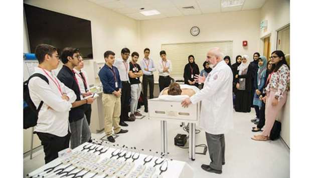 WCM-Qu2019s Dr Mohamud Verjee introduces high school students to Harvey, the collegeu2019s robotic learning aid.