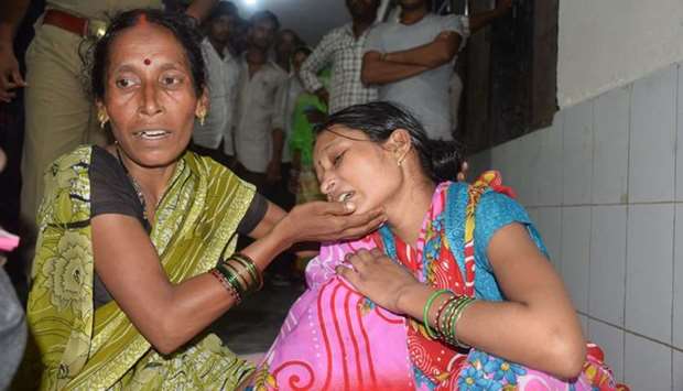 Relatives mourn the death of a children at Baba Raghav Das Hospital in Gorakhpur district of the Indian northern state Uttar Pradesh