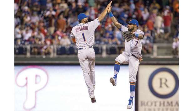 New York Mets shortstops Amed Rosario (left) and Jose Reyes celebrate their victory against the Philadelphia Phillies at Citizens Bank Park in Philadelphia, Pennsylvania, on Thursday. (USA TODAY Sports)