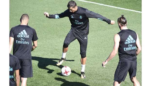 Weu2019re Ready for Barca: Real Madridu2019s Portuguese forward Cristiano Ronaldo (C) takes part in a training session at Real Madrid sport city in Madrid yesterday.