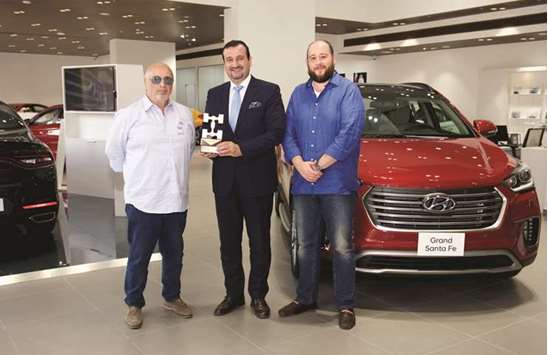 Skyline Automotiveu2019s Paiman El Malla with the award for the Grand Santa Fe.