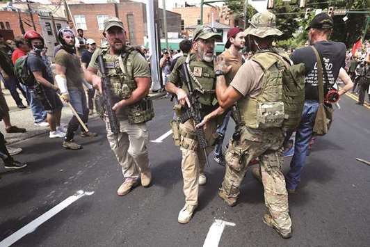 Members of the u201calt-rightu201d with body armour and combat weapons evacuate comrades who were pepper sprayed in Charlottesville, Virginia.
