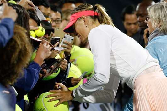 Maria Sharapova signs autographs for fans after beating Jennifer Brady (USA) in the Bank of the West Classic tennis tournament at Stanford University on Monday. PICTURE: Stan Szeto-USA TODAY Sports