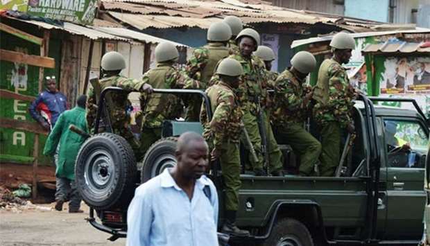 Kenyan riot police officers patrol in Kawangware, Nairobi on Saturday.