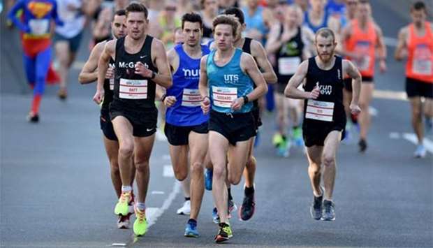 Leading runners, including Harry Summers (third left in blue), take part in the annual City2Surf race in Sydney on Sunday.