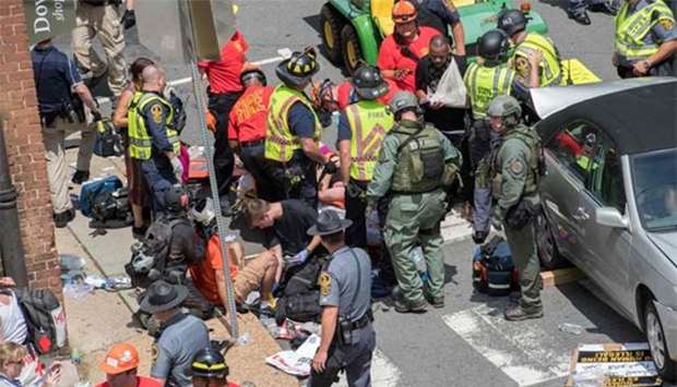 People receive first-aid after a car ran into a crowd of protesters in Charlottesville, Virginia on Saturday.