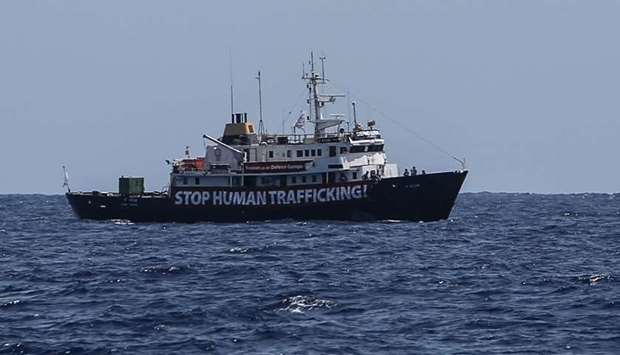 A banner that reads 'Stop Human Trafficking' attached to the side of the C-Star vessel as it sails in the Mediterranean Sea