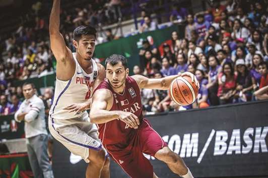 Qatar's Abdulrahman Saad (right) in action against Philippines during the 2017 FIBA Asia Cup basketball tournament in Beirut, Lebanon, yesterday.