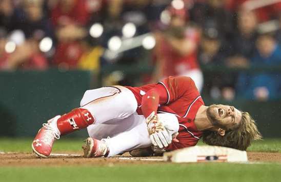Washington Nationals right fielder Bryce Harper grimaces in pain after suffering an knee injury in the first inning against the San Francisco Giants at Nationals Park in Washington. (USA TODAY Sports)