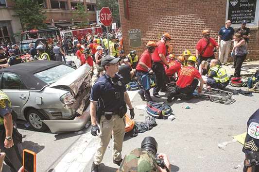A woman is received first-aid after a car accident ran into a crowd of protesters in Charlottesville on Saturday.