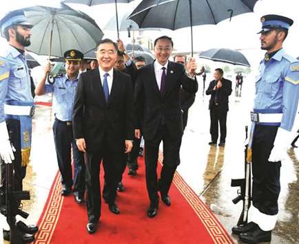 Chinese Vice-Premier Wang Yang (centre-left) is flanked by Chinese ambassador to Pakistan Sun Weidong (centre-right) as he arrives at the Pakistanu2019s military Chaklala airbase in Rawalpindi yesterday. The Chinese vice-premier is in Islamabad to participate in the 70th Independence Day celebrations of Pakistan.