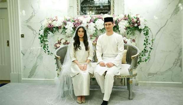 Dennis Muhammad Abdullah of the Netherlands posing with his bride, Princess Tunku Tun Aminah Sultan Ibrahim, the only daughter of the Sultan of Johor, after their wedding at Istana Bukit Serene in Johor Bahru.