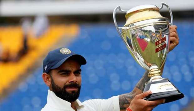 India's captain Virat Kohli holds the trophy after winning the Test series against Sri Lanka, in Pallekele on Monday.