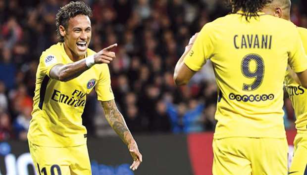 PSG forward Neymar (L) celebrates after scoring a goal against Guingamp.
