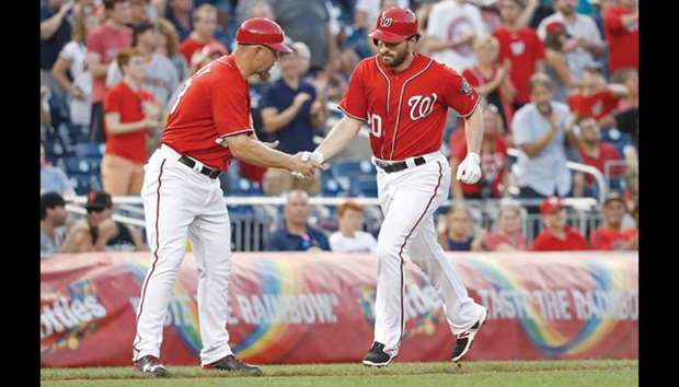 Washington Nationals second baseman Daniel Murphy (20) is congratulated by Nationals third base coach Bob Henley (13) while rounding the bases after hitting a solo home run against the San Francisco Giants in the third inning in game two of a baseball doubleheader at Nationals Park. PICTURE: Geoff Burke-USA TODAY Sports