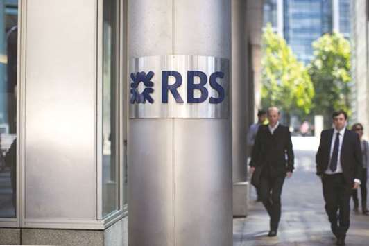 A logo is seen on a pillar outside the Royal Bank of Scotland Group (RBS) headquarters in London. Unite said there would be 950 full-time IT staff by 2020, compared with 2,200 in 2016, but a spokeswoman for RBS said it had not yet begun any formal consultations on job cuts and no numbers had been set.