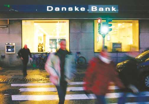 Pedestrians walk past a Danske Bank branch in Copenhagen. Danskeu2019s deposits have risen 11% over the past 21 months, reaching 914bn kroner ($145bn) at the end of June (excluding repurchase agreements), second-quarter results show.