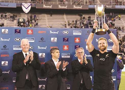 In this October 1, 2016, picture, New Zealandu2019s Kieran Read (right) holds up the Rugby Championship trophy after defeating Argentina at Jose Amalfitani stadium in Buenos Aires, Argentina. (AFP)