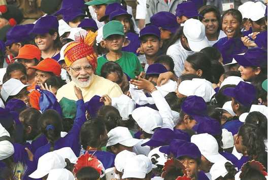 Prime Minister Narendra Modi greets school children after addressing the nation from the historic Red Fort during Independence Day celebrations in Delhi yesterday.