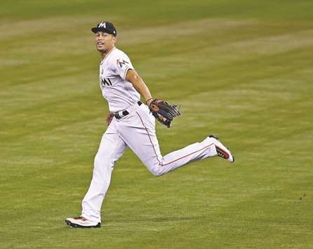 Giancarlo Stanton of Miami Marlins runs in from the outfield in the fourth inning against San Francisco Giants on a night when he broke the teamu2019s single-season home run record in Miami on Monday. (Miami Herald/TNS)