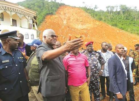 Sierra Leone President Ernest Bai Koroma visits the site of a mudslide near Freetown after landslides struck the capital of the west African state.