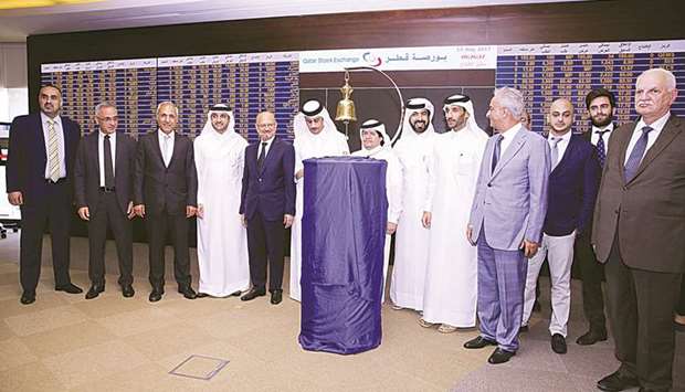 Qatar Stock Exchange officials and other dignitaries during the listing ceremony of Investment Holding Group held in Doha yesterday.