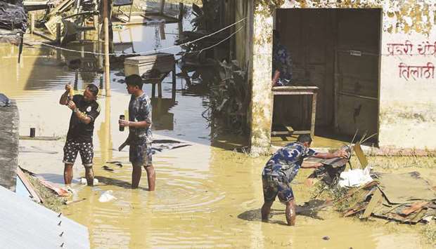 Nepali police officers clean their office area at Tilathi Village in Saptari district, some 450km southeast of Kathmandu.