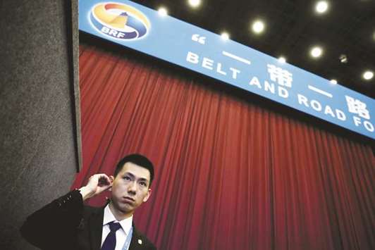 A security guard stands at the entrance to the opening ceremony of the Belt and Road Forum in Beijing. Unveiled in 2013, the Belt and Road project is aimed at building a modern-day u201cSilk Roadu201d, connecting China by land and sea to Southeast Asia, Pakistan and Central Asia, and beyond to the Middle East, Europe and Africa.