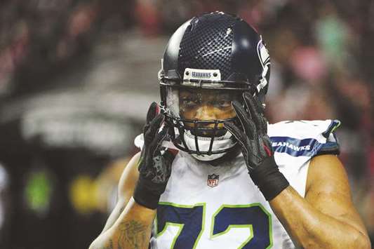 In this January 13, 2017, picture, Michael Bennett of Seattle Seahawks looks on in the game against the Atlanta Falcons in Atlanta, Georgia. Bennett chose to remain seated during the playing of the Stars and Stripes in the Sundayu2019s pre-season win over the Los Angeles Chargers, emulating Colin Kaepernicku2019s protest last season which drew a firestorm of criticism. (AFP)