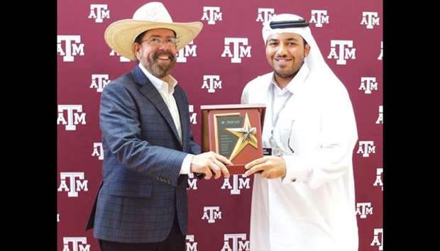 A Tamuq student receiving an award.