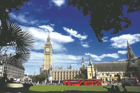 Tourists view the Elizabeth Tower, which houses the Great Clock and the u2018Big Benu2019 bell, at the Houses of Parliament, in London.