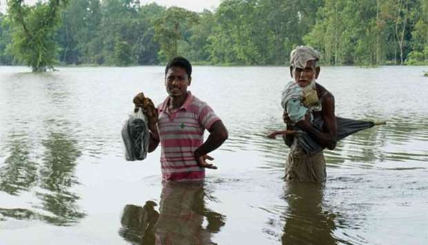 Bangladeshis walk in floodwaters in Kurigram, northern Bangladesh earlier this week.