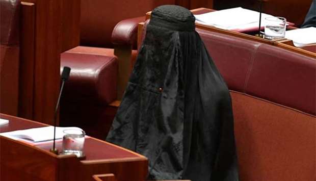 :Australian One Nation party leader Pauline Hanson wears a burqa in the Senate chamber at Parliament House in Canberra on Thursday.