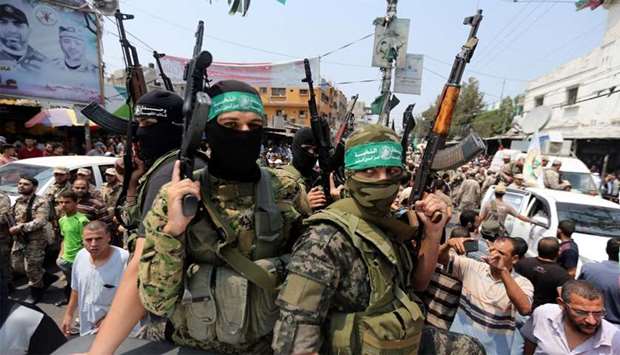 Palestinian Hamas militants attend the funeral of their comrade in Rafah in the southern of Gaza Str