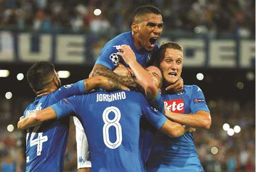 Napoliu2019s Jorginho celebrates scoring their second goal with teammates during their Champions League Qualifying Play-Off First Leg match against Nice in Naples, Italy.