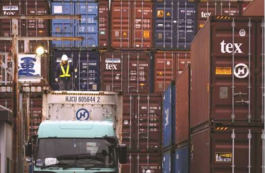 A labourer works in a container area at a port in Tokyo. Japanu2019s exports to the US rose 11.5% in July from a year earlier to mark the sixth straight month of gains.