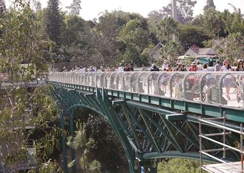 The first San Diego Zoo visitors to cross the new Canopy Bridge, a 450-foot long pedestrian bridge linking the front of the zoo to the back of the zoo, were treated to a parade, complete with mascots, puppeteers, bubbles and a brass band.
